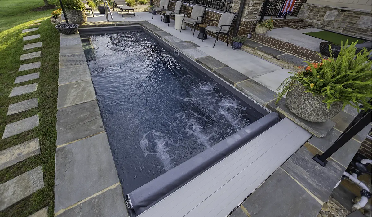 Integra automatic pool cover tracks creating a tight safety seal along the pool deck to prevent gaps.